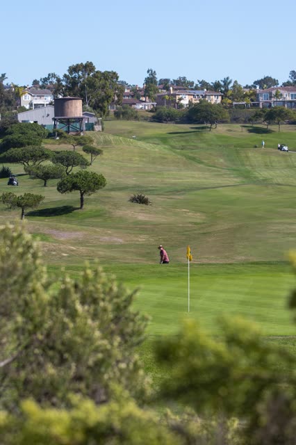 The country inland, homes and traffic in Encinitas, with people walking.