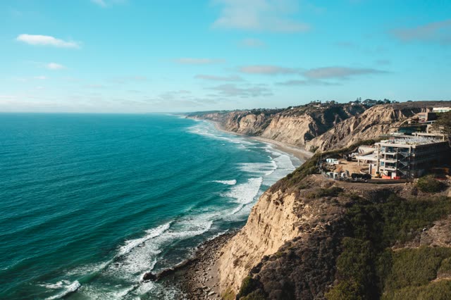 Aerial view of the cliffs, the surf and the ocean at La Jolla Farms.