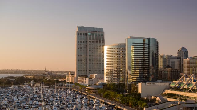 Low aerial view of the downtown streets, the skyline and boats at Embarcadero.