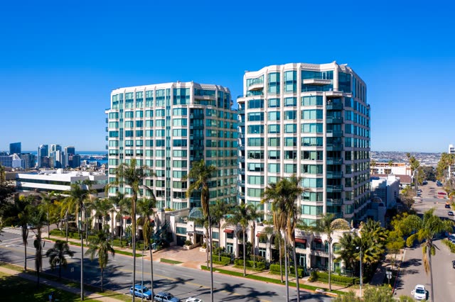 Low aerial view of the downtown streets, the skyline and palm trees at Bankers Hill.
