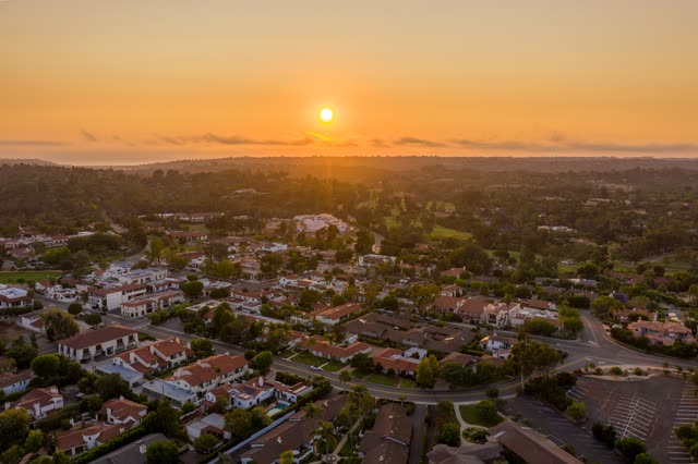 Aerial view of a residential street, palm trees and homes at Covenant.