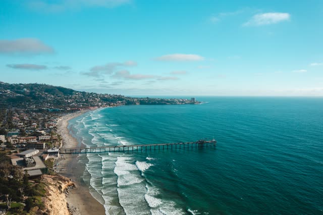 Aerial view of the beach, the surf and the pier at La Jolla Farms.