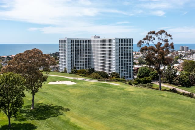 Aerial view of a residential street, the ocean and homes at La Jolla Country Club.