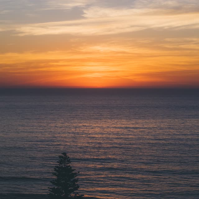 Elevated view of the beach, the ocean and open country at Moonlight Beach.