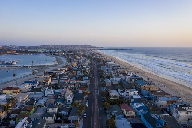 Aerial view of a residential street, boats and the ocean in Mission Bay.