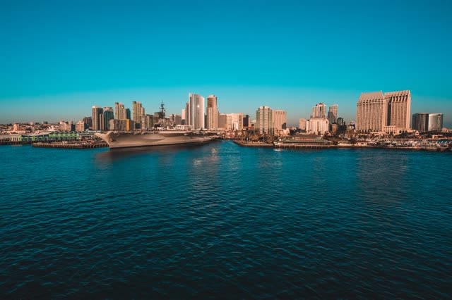 Low aerial view of the harbor, the pier and the skyline at San Diego Marina.