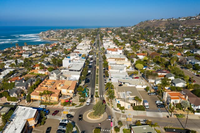 Aerial view of a residential street, the surf and palm trees at Bird Rock.