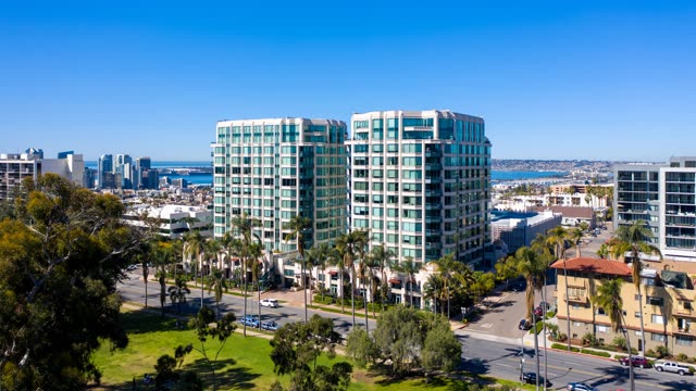 Aerial view of a residential street, the skyline and palm trees at Bankers Hill.