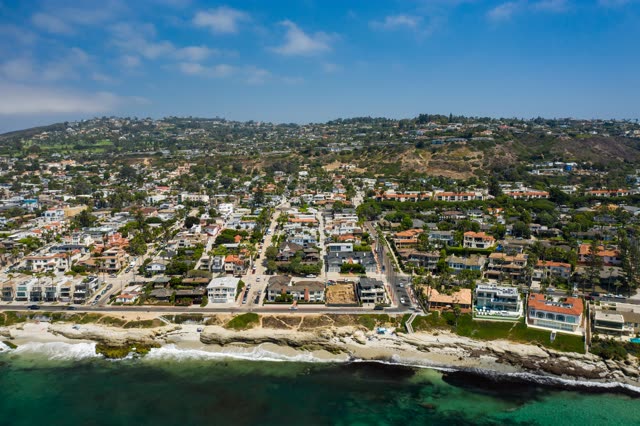 Aerial view of a residential street, palm trees and the ocean at Windansea.