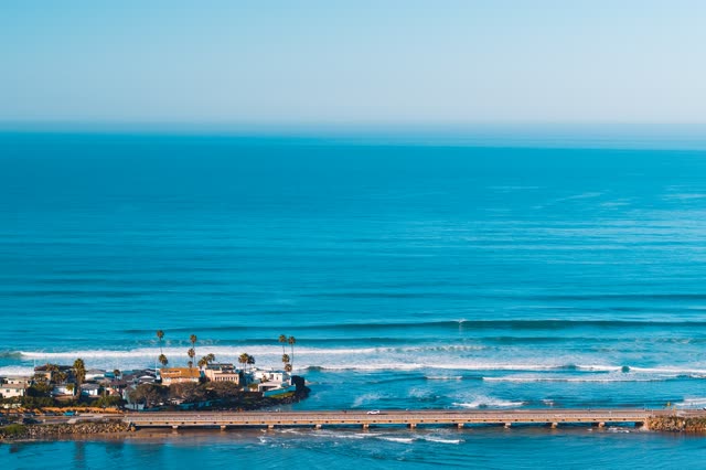 Aerial view of the beach, the surf and the bridge in Del Mar.