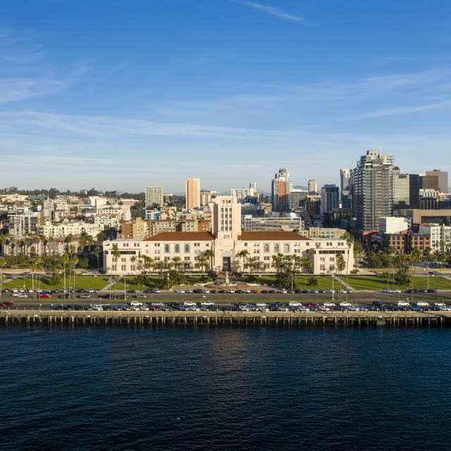 Low aerial view of the downtown streets, the skyline and palm trees at Waterfront.