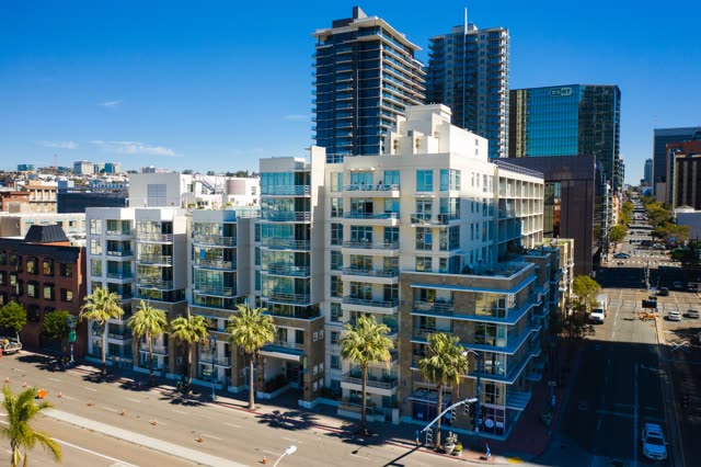 Low aerial view of the downtown streets, the skyline and palm trees at Waterfront.