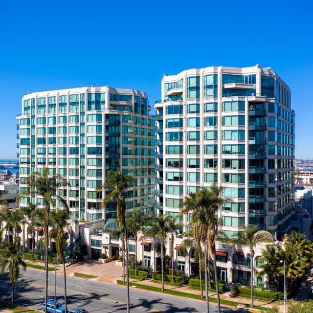 Low aerial view of the downtown streets, palm trees and the bay at Bankers Hill.