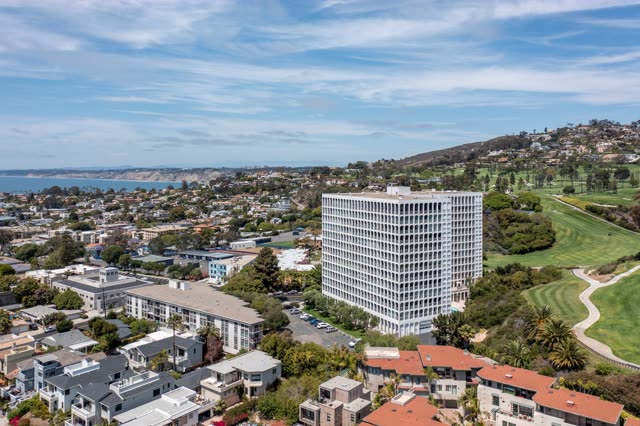 Aerial view of a residential street, palm trees and the ocean at La Jolla Country Club.