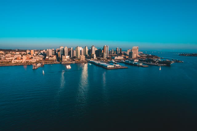 Aerial view of the downtown streets, the skyline and boats at San Diego Marina, with boats out.