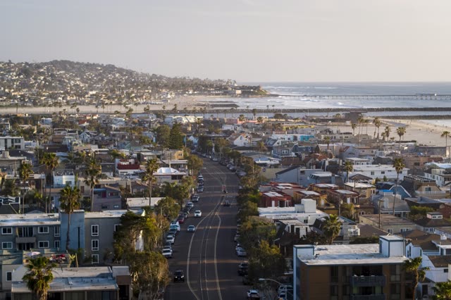 Aerial view of a residential street, the pier and palm trees in Mission Bay.