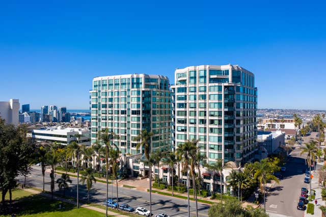 Low aerial view of the downtown streets, the skyline and palm trees at Bankers Hill.