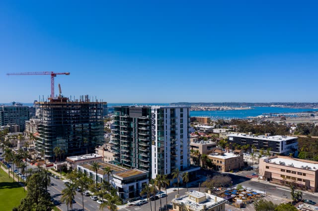 Aerial view of the downtown streets, the skyline and boats at Bankers Hill, with a work crew on site.