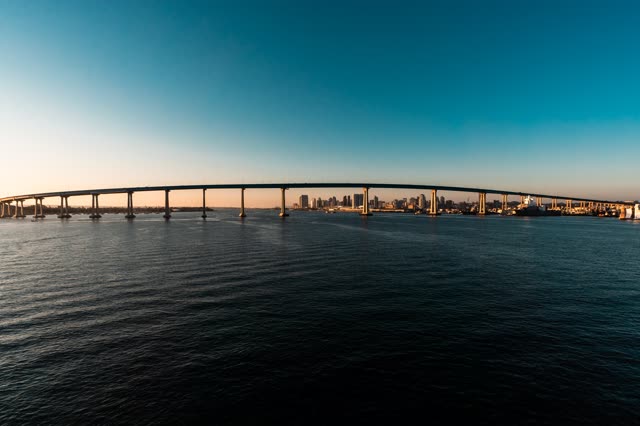 Helicopter shot of the Coronado Bridge with Downtown San Diego in the Background during Sunset | Photo – 5