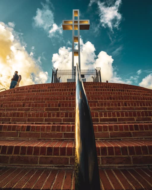 A park, the buildings and open country at Mount Soledad, with people walking.