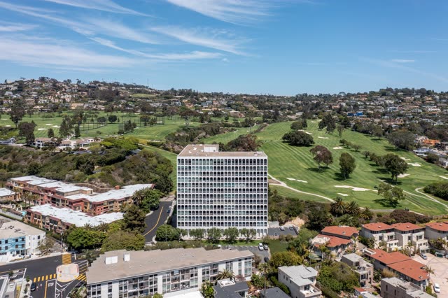 Aerial view of a residential street, palm trees and homes at La Jolla Country Club.