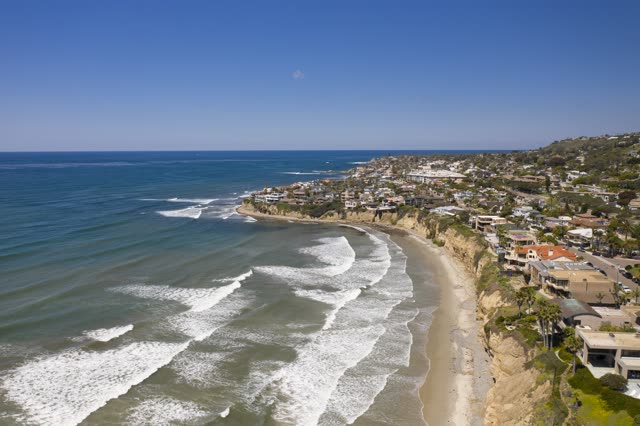 Aerial view of the cliffs, the surf and palm trees in Pacific Beach.