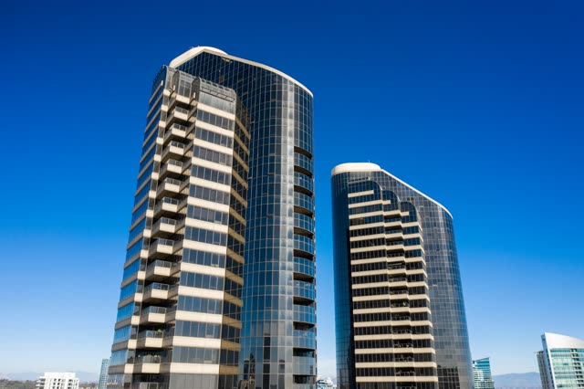Low aerial view of the downtown streets, the skyline and the buildings at San Diego Marina.
