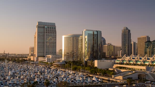 Low aerial view of the downtown streets, the skyline and boats at Embarcadero.
