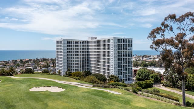 Aerial view of a residential street, the ocean and homes at La Jolla Country Club.