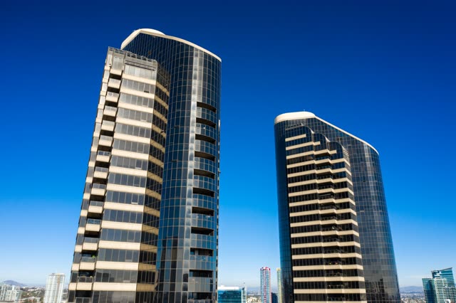 Low aerial view of the downtown streets, the skyline and the buildings at San Diego Marina.