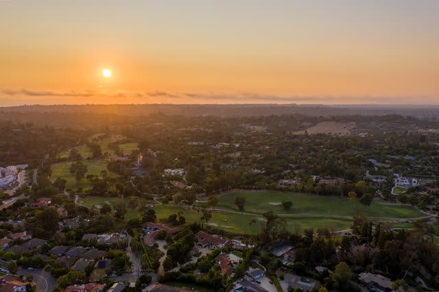 Aerial view of a residential street, homes and open country at Covenant.