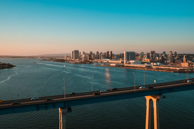 Helicopter shot of the Coronado Bridge with Downtown San Diego in the Background during Sunset | Photo – 1