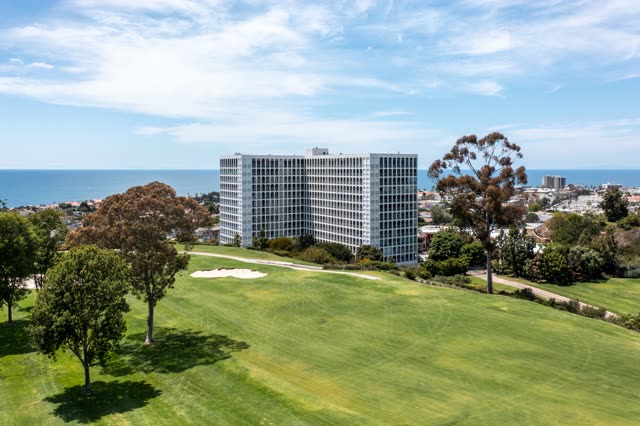 Aerial view of a residential street, the ocean and homes at La Jolla Country Club.