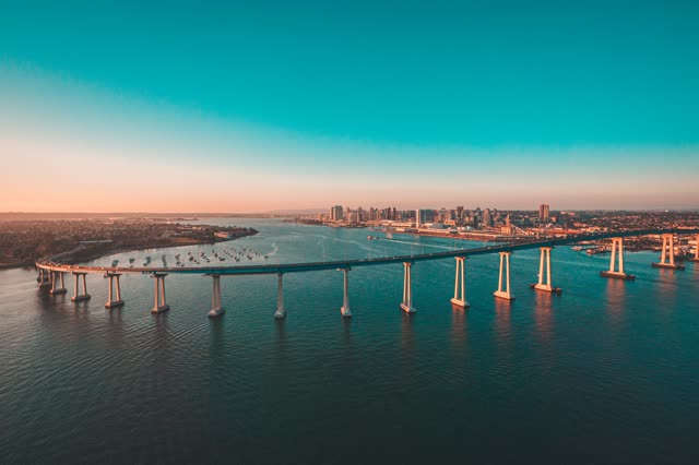 Helicopter shot of the Coronado Bridge with Downtown San Diego in the Background during Sunset | Photo – 2