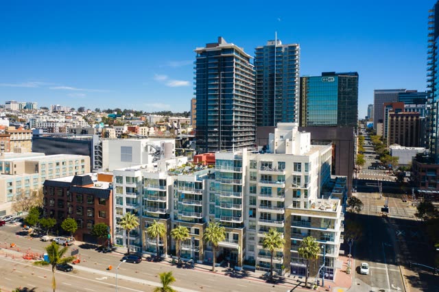 Low aerial view of the downtown streets, the skyline and palm trees at Waterfront.