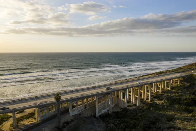 Aerial view of the cliffs, the surf and the bridge in Del Mar.