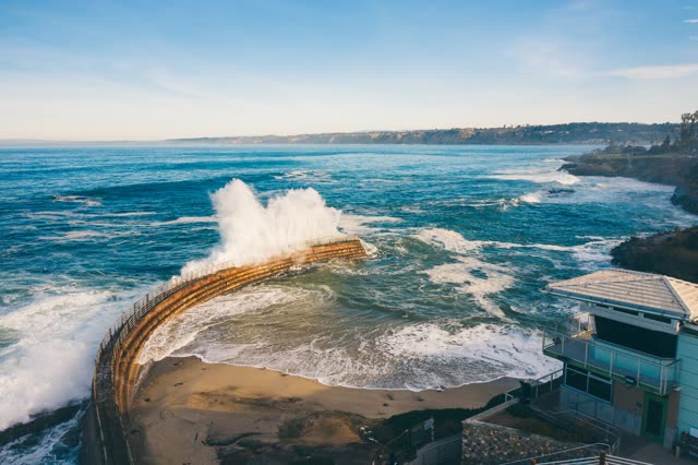 Waves breaking on the seawall at Children’s Pool in La Jolla | Drone Photo – 3