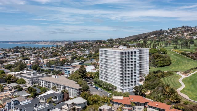 Aerial view of a residential street, palm trees and the ocean at La Jolla Country Club.