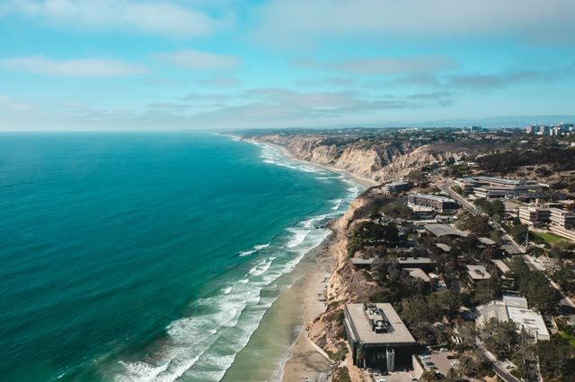 Aerial view of the cliffs, the surf and the ocean at La Jolla Farms.