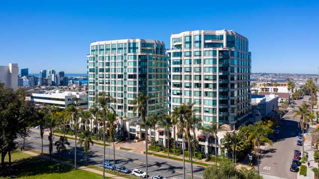 Low aerial view of the downtown streets, the skyline and palm trees at Bankers Hill.