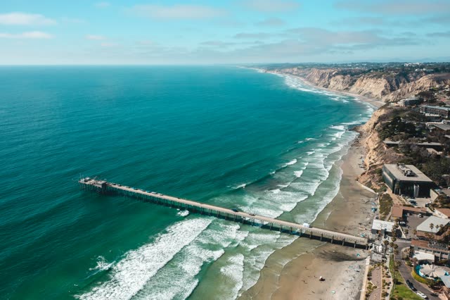 Aerial view of the beach, the surf and the pier at La Jolla Farms.