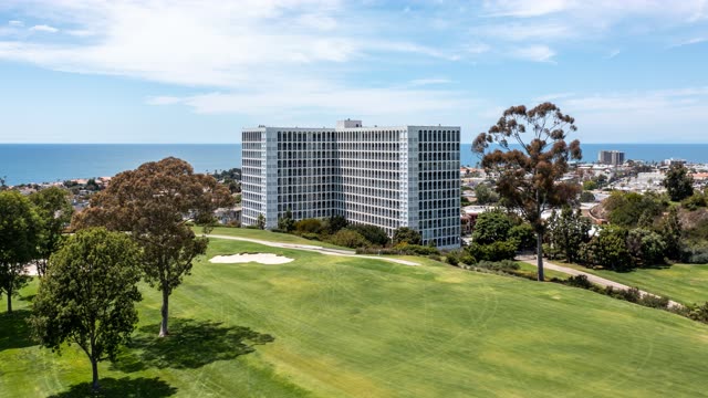 Aerial view of a residential street, the ocean and homes at La Jolla Country Club.