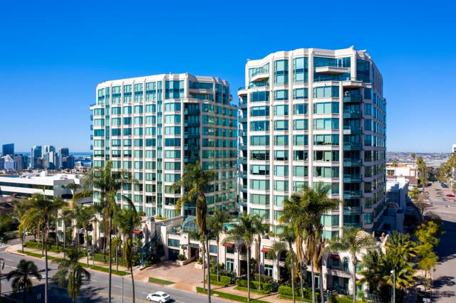 Low aerial view of the downtown streets, the skyline and palm trees at Bankers Hill.