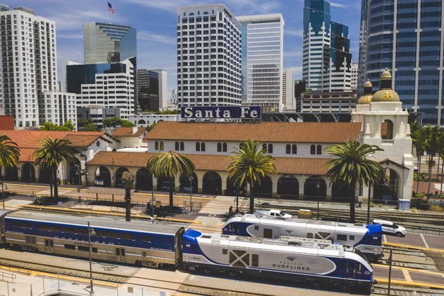 Low aerial view of the downtown streets, the skyline and palm trees at Waterfront.