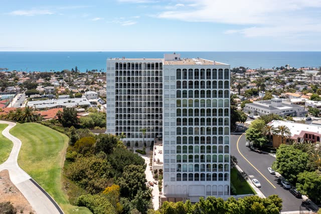 Aerial view of a residential street, palm trees and the ocean at La Jolla Country Club.