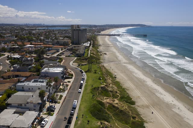 Aerial view of the beach, the surf and the pier in Pacific Beach.