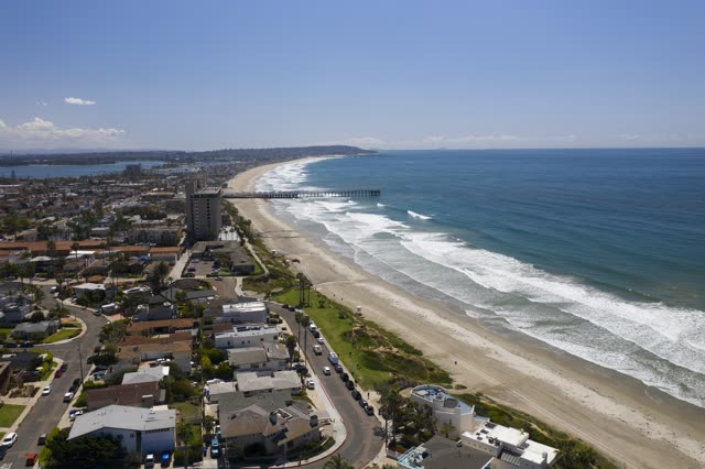 Aerial view of the beach, the surf and the pier in Pacific Beach.