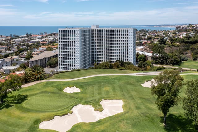 Aerial view of a residential street, palm trees and the ocean at La Jolla Country Club.