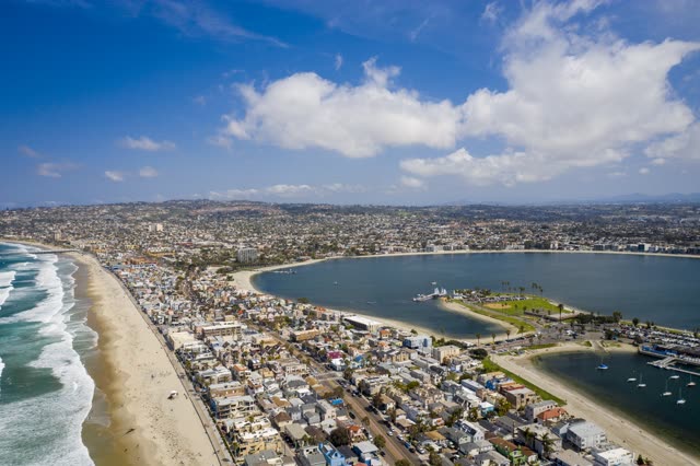 Aerial view of the beach, the surf and boats in Mission Bay.