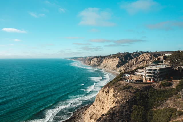 Aerial view of the cliffs, the surf and the ocean at La Jolla Farms.
